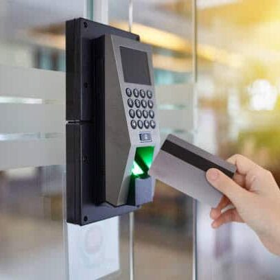 Young woman hold key card to access door office security entrance device