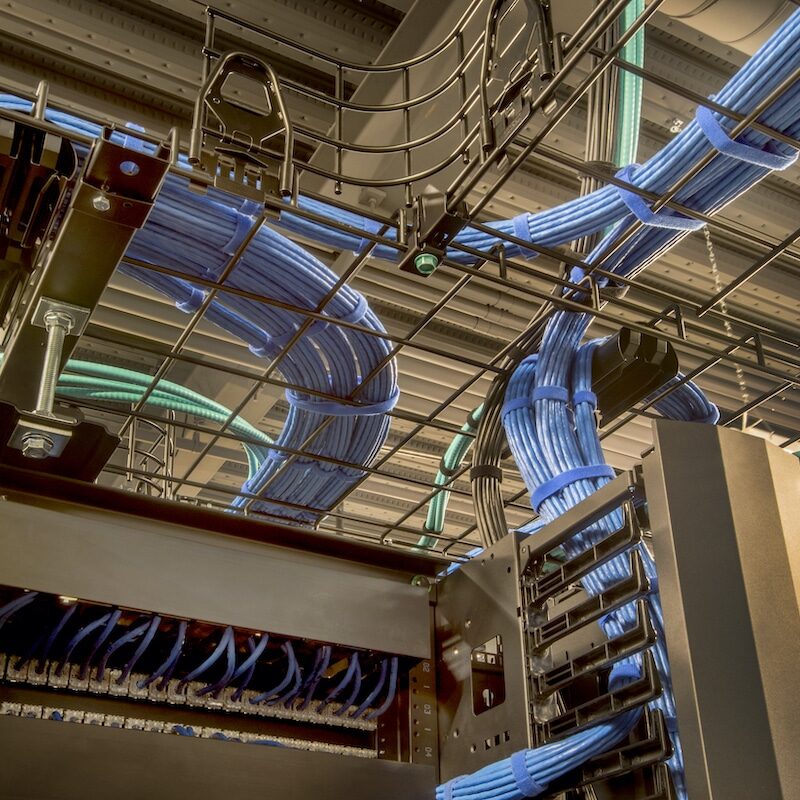 Cable trays in a data center with cat 5 and optic fiber cables.